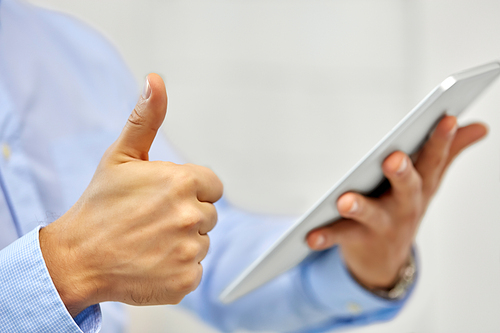 business, people and technology concept - close up of male hands with tablet pc computer showing thumbs up