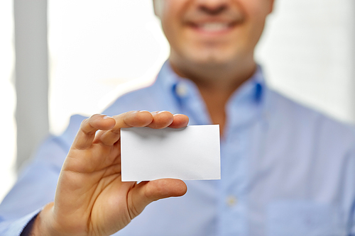 business and people concept - close up of smiling man holding empty white card