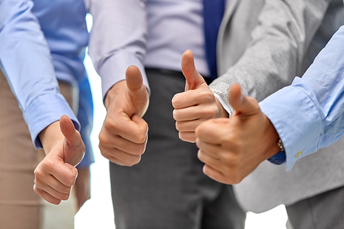 people, gesture and success concept - close up of business team hands showing thumbs up