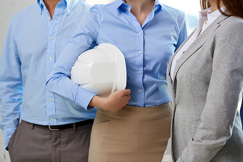 construction, building and people concept - close up of business team with hard hat or safety helmet