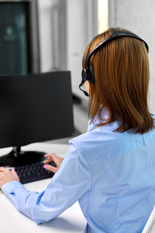 business, people and technology concept - businesswoman or helpline operator with headset and computer at office