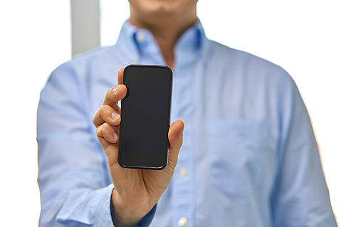 business, people and technology concept - close up of businessman showing smartphone black blank screen