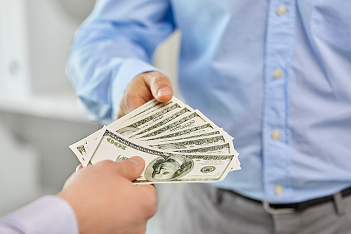 business, people and finances concept - close up of businessmen's hands holding american dollar money