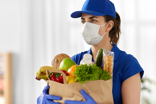 health protection, safety and pandemic concept - delivery woman in face mask and gloves holding paper bag with food