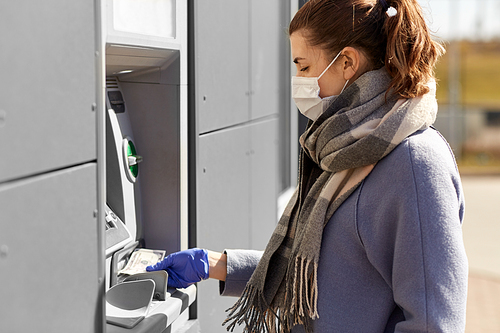 finance, bank and hygiene concept - woman in medical mask and glove with cash money at atm machine