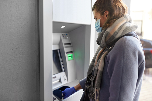 finance, bank and hygiene concept - woman in medical mask and glove entreing code at atm machine