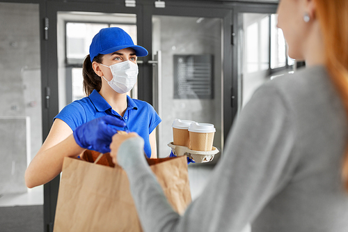 health protection, safety and pandemic concept - delivery woman in protective face mask and gloves giving paper bag with food and drinks to female customer at office