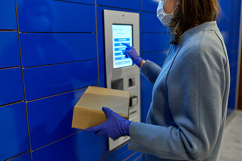 health care,  delivery and pandemic concept - close up of woman wearing face protective medical mask for protection from virus disease with box at automated parcel machine