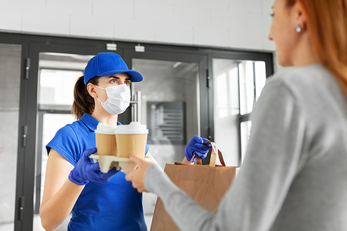 health protection, safety and pandemic concept - delivery woman in protective face mask and gloves giving paper bag with food and drinks to female customer at office