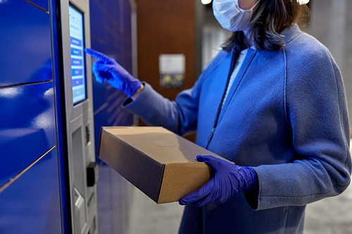 health care,  delivery and pandemic concept - close up of woman wearing face protective medical mask for protection from virus disease with box at automated parcel machine
