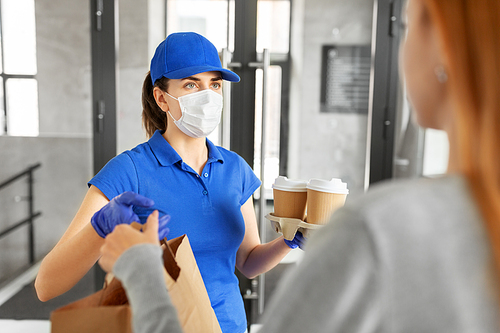 health protection, safety and pandemic concept - delivery woman in protective face mask and gloves giving paper bag with food and drinks to female customer at office