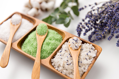 beauty, bath and wellness concept - 씨솔트 with lavender, eucalyptus cinerea, cotton flowers and spoons on wooden tray