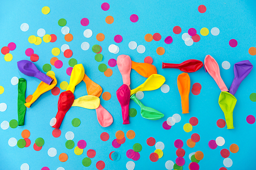 lettering, celebration and decoration concept - word party made of colorful balloons and confetti on blue background