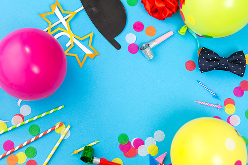 celebration and decoration concept - birthday party props, balloons and colorful confetti on blue background