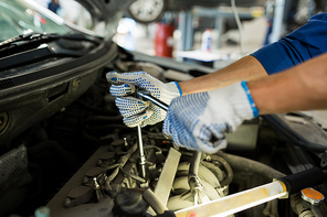 car service, repair, maintenance and people concept - auto mechanic man with wrench and lamp working at workshop