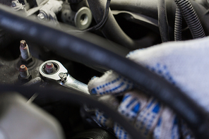 car service, repair, maintenance and people concept - auto mechanic man with wrench and lamp working at workshop