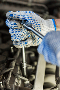 car service, repair, maintenance and people concept - auto mechanic man with wrench and lamp working at workshop