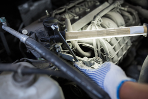 car service, repair, maintenance and people concept - auto mechanic man with wrench and lamp working at workshop
