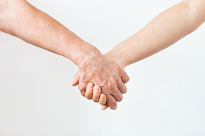 people, age and body parts concept - close up of senior and young woman holding hands