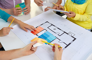 interior design, architecture and people concept - close up of architects team working with blueprint and color palettes