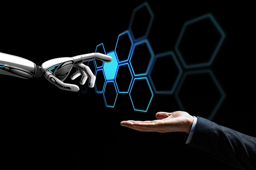 future technology, artificial intelligence and business concept - human hand and robot touching virtual network hologram over black background