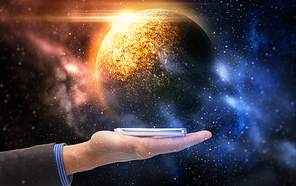 business, future technology and people concept - businessman hand holding smartphone over planet in space background