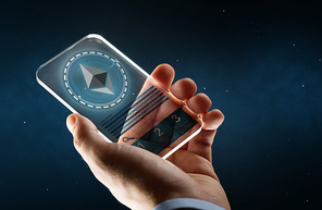 business, cryptocurrency and future technology concept - close up of businessman hand with transparent smartphone and ethereum symbol on screen over space background