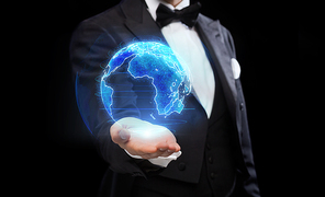 business, globalization and magic concept - close up of magician with earth hologram over black