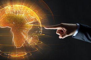 business, globalization and future technology concept - close up of businessman hand with earth hologram over black