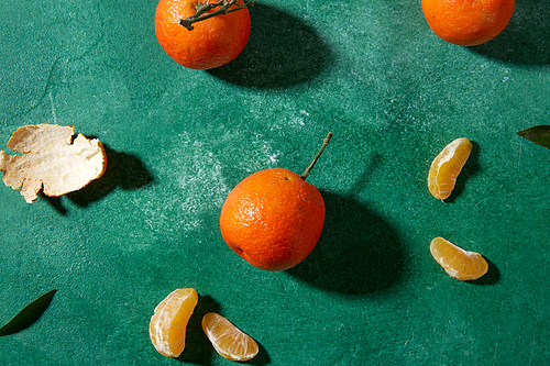 food, healthy eating and fruits concept - still life with mandarins on green background