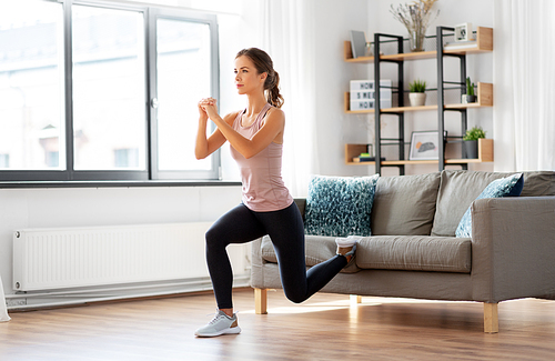 sport, fitness and healthy lifestyle concept - young woman exercising at home