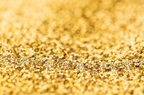 party, texture and holidays concept - golden glitters background