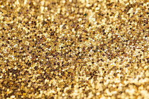 party, texture and holidays concept - golden glitters background