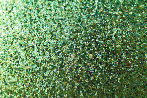party, texture and holidays concept - green glitters or sequins background