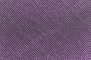 textile, party and texture concept - shimmering violet fabric background