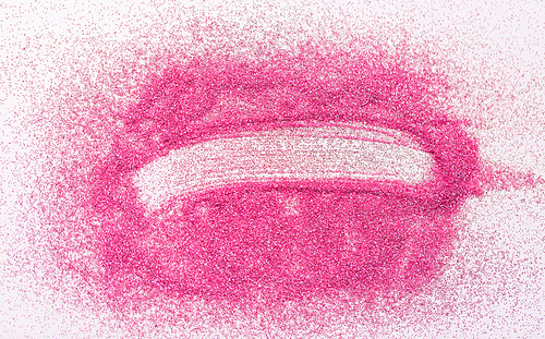 party make up and holidays concept - stroke on pink glitters on white background