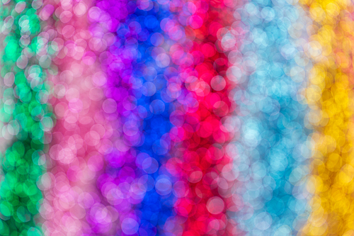 party, texture and holidays concept - multicolored glitters or sequins bokeh background