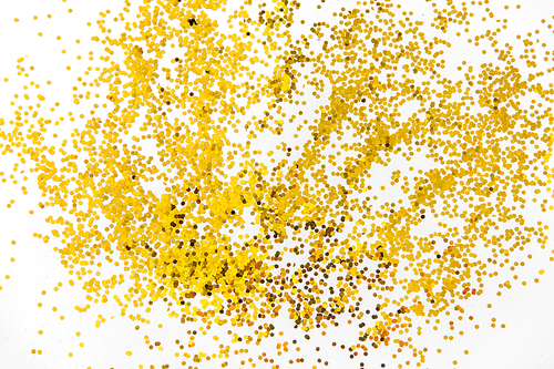party, decoration and holidays concept - golden glitters on white background