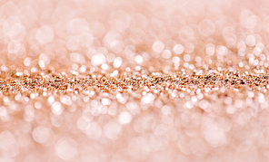 party, texture and holidays concept - rose gold glitter background