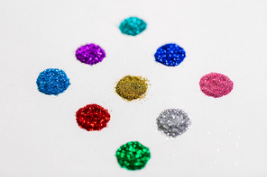 party, decoration and holidays concept - set of different color glitters on white background