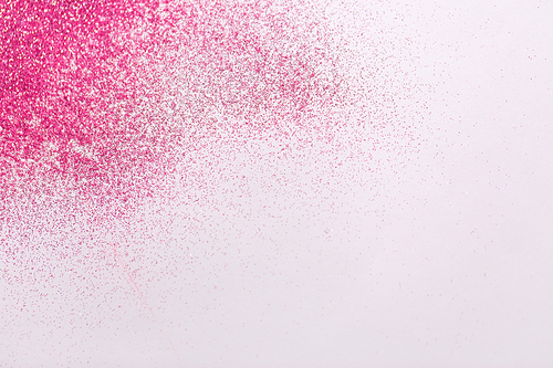 party, decoration and holidays concept - pink glitters on white background