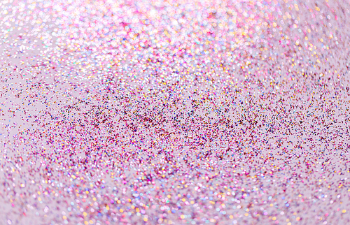 party, decoration and holidays concept - multicolored glitters on white background