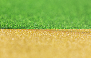 party, texture and holidays concept - green and golden yellow glitters or sequins backgrounds