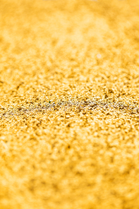 party, texture and holidays concept - golden glitters background