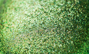 party, texture and holidays concept - green glitters or sequins background
