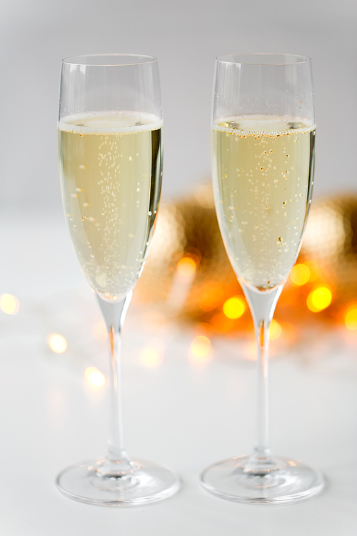 christmas, holidays and celebration concept - two glasses of champagne