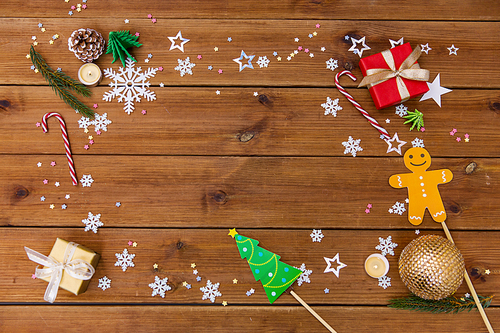 christmas and holidays concept - electric garland and decorations on wooden background