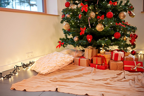 holidays, new year and celebration concept - gift boxes under decorated christmas tree at home