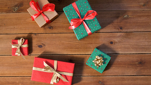 christmas, holidays and celebration concept - gift boxes on wooden boards from top