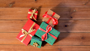 christmas, holidays and celebration concept - gift boxes on wooden boards from top